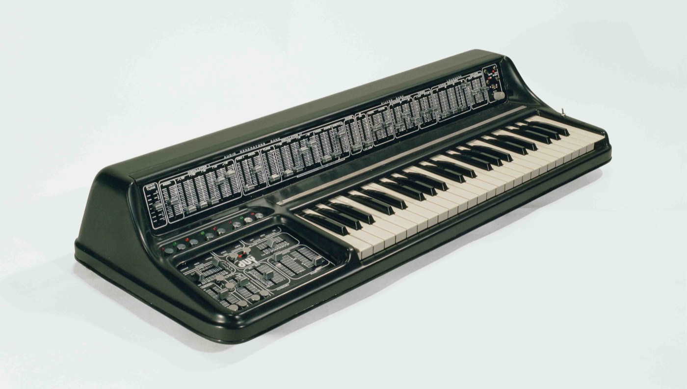 A DUY Alpha 1024 synthesiser built by hand in Barcelona: two banks of sliders above a keyboard, the panel lettered AUDIO GENERATORS BANK, and the duy logo below it.
